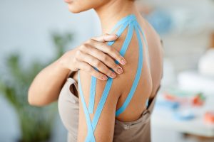 Woman with Physio Tape on Shoulder